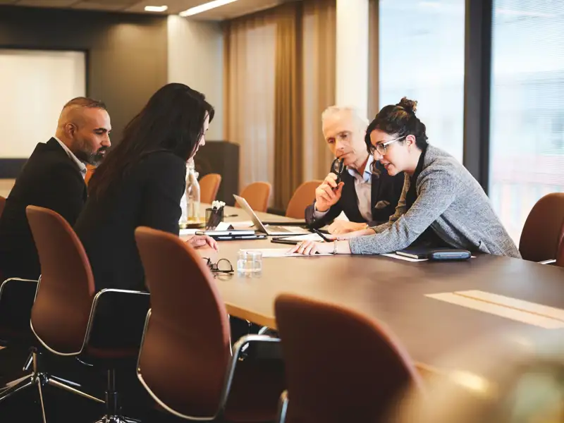 Coworkers meeting in a board room.